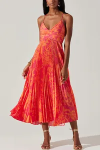 Close-up of vibrant pink and orange floral print on a pleated midi beach dress.
