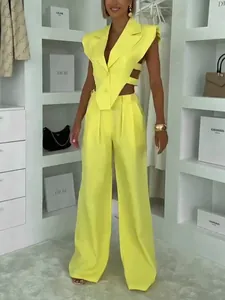 Chic yellow two-piece set featuring a sleeveless waist-cutout vest and wide-leg pants