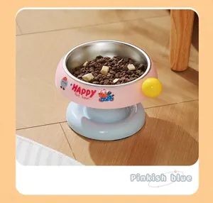 Detail view of an elevated pink and blue stainless steel pet bowl filled with dry food.