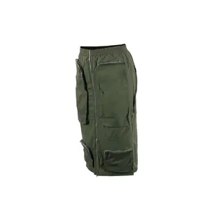 Detail of olive green cargo midi skirt with multiple zipper pockets on white background