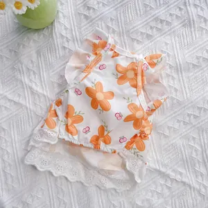 Detailed view of the vibrant floral pattern and delicate lace hem on a summer pet dress