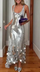 Full view of elegant sleeveless silver sequined maxi dress with tassel hem detail