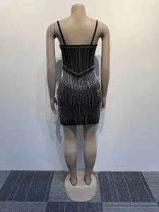 Back view of a black bodycon cami dress with vertical rhinestone stripes on mannequin