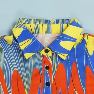 Close-up of vibrant abstract print lapel dress with black button details
