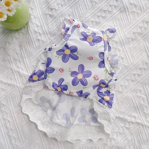 Close-up of a floral pet summer dress with purple flowers and white lace trim detail