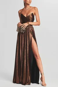 Close-up detail of bronze metallic pleated strapless evening gown with a high slit.