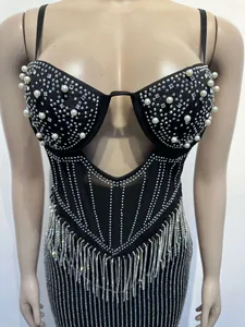Detail of black sling dress with pearls, rhinestones, and silver fringe tassels.