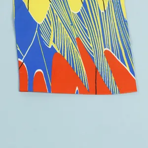 Detail shot of the colorful abstract pattern and high-quality fabric on a slim fit dress.