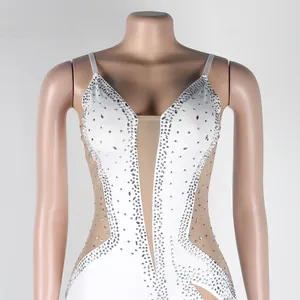 Close-up detail of sexy white evening dress with transparent mesh and rhinestones