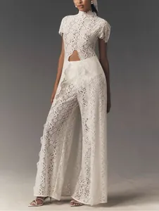 Detailed look of white floral lace fabric on elegant two-piece set with front slit
