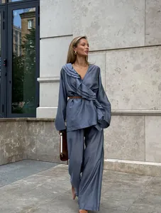 Full lifestyle view of women's tencel ruffle wrap top and wide leg pants set