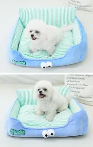 Detail view of soft blue and green striped pet bed with eyes for small dogs and cats