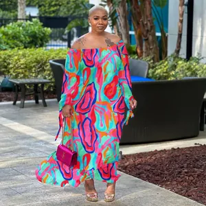 Vibrant multi-color abstract print off-the-shoulder maxi dress shown on model outdoors