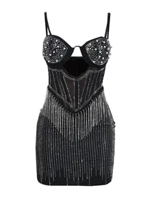 Detailed macro shot of black bodycon dress featuring hot-fix rhinestones and pearls