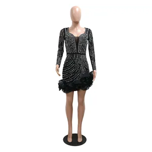 Elegant black long-sleeved mini dress with intricate rhinestone patterns and ruffle hem