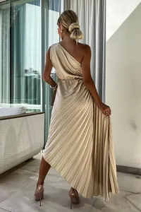Detail of elegant champagne pleated one-shoulder dress with irregular hemline.