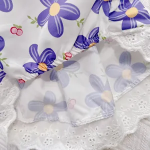 Close-up detail of purple floral print and white lace hem on breathable pet summer dress