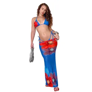 Full view detail of a sexy blue three-piece bikini set featuring vibrant red floral prints
