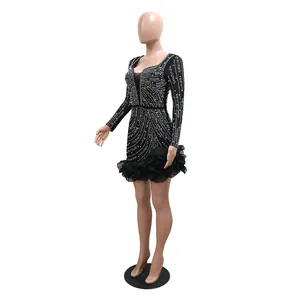Elegant black long sleeve mini dress featuring intricate rhinestone beading and ruffles