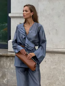 Elegant blue tencel wrap top and wide-leg pants set with ruffle details on model