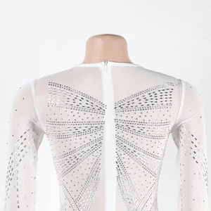 Close-up of white sheer evening dress with silver rhinestone wing pattern on back