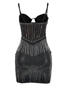 Back view of black bodycon dress featuring silver rhinestone stripes and mesh corset panels.