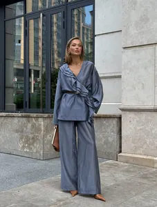 Elegant Tencel two-piece set with ruffle wrap top and wide-leg pants in dusty blue.