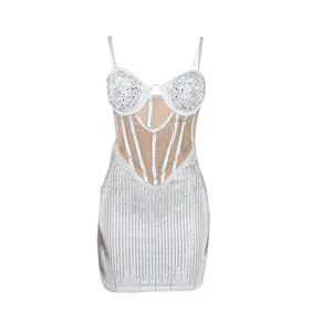 Close-up detail of white bodycon mini dress featuring vertical rhinestone stripes and pearls.