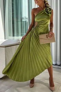 Detail view of a lime green one-shoulder pleated cutout evening gown with floral shoulder accent