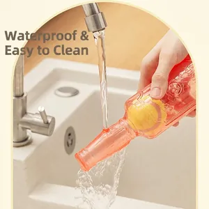 Durable waterproof squeaky dog wine bottle toy with internal tennis ball being rinsed