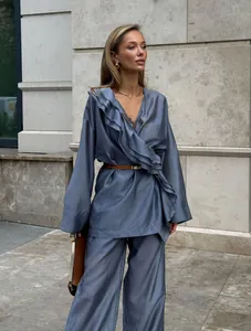 Elegant blue Tencel two-piece set with ruffle wrap top and flowing wide-leg trousers
