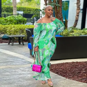 Close-up of vibrant green floral off-shoulder maxi dress for women on outdoor model