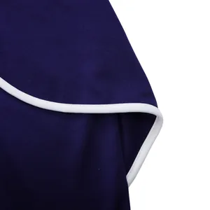 Detailed close-up showing the navy blue fabric texture and white piping on an elegant dress