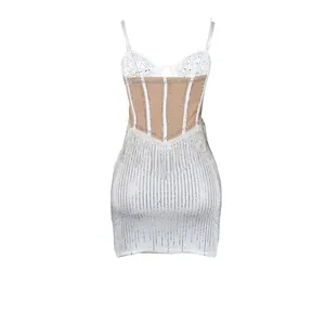 Back view of white bodycon mini dress featuring rhinestone corset and sheer mesh panels