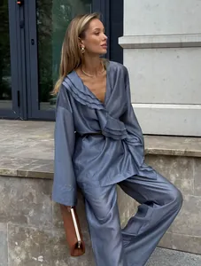 Chic dusty blue tencel two-piece set featuring a ruffled wrap top and wide-leg trousers