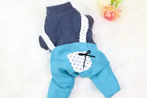 Detail view of warm dog overalls with grey knit top and blue pants featuring polka dots