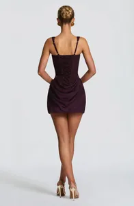 Detailed back view of plum sleeveless corset mini dress featuring draped skirt