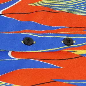 Macro view of colorful abstract print fabric and black buttons on a slim fit dress