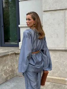 Back view of elegant blue-grey tencel wrap top and wide-leg pants set with belt