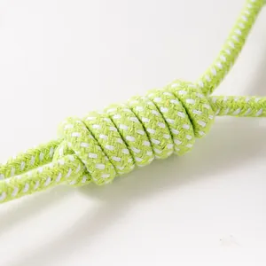 Close-up of durable lime green and white braided cotton rope knot for dog chew toys.