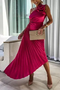 Detail view of fuchsia one-shoulder pleated satin dress with shoulder flower detail.