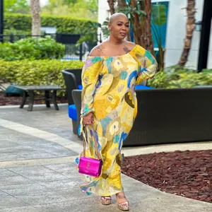 Outdoor shot of a stylish floral print off-shoulder maxi dress worn by a model