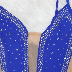 Close-up detail of a royal blue evening dress with sparkling rhinestones and mesh