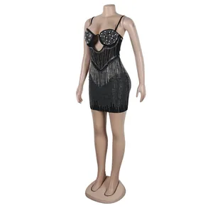 Detailed macro view of black bodycon mini dress with rhinestone and pearl embellishments