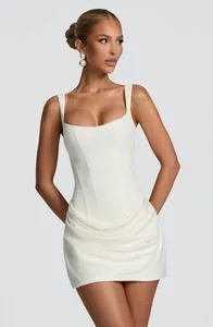Close-up detail of a white sleeveless bodycon dress with corset bodice and draped skirt.