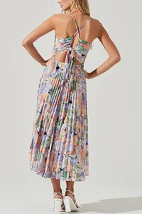 Detailed back view of a floral pleated midi dress with cross strap and tie-back