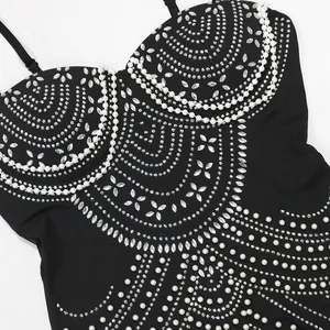 Detailed view of the intricate rhinestone and pearl patterns on the black bodice.