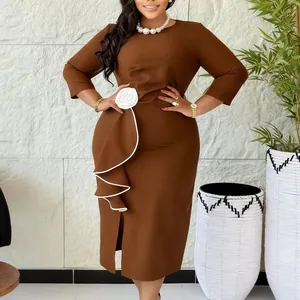 Detail of elegant plus size brown midi dress featuring 3D white flower and side ruffle.