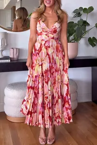 Elegant floral print V-neck pleated maxi dress shown in a stylish home lifestyle setting