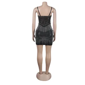 Back view of a black bodycon mini dress with rhinestone stripes and mesh corset details
